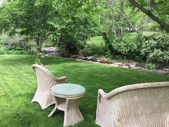 Enjoy the peaceful, park-like setting of your large back yard with a babbling brook in the far back portion of the property.