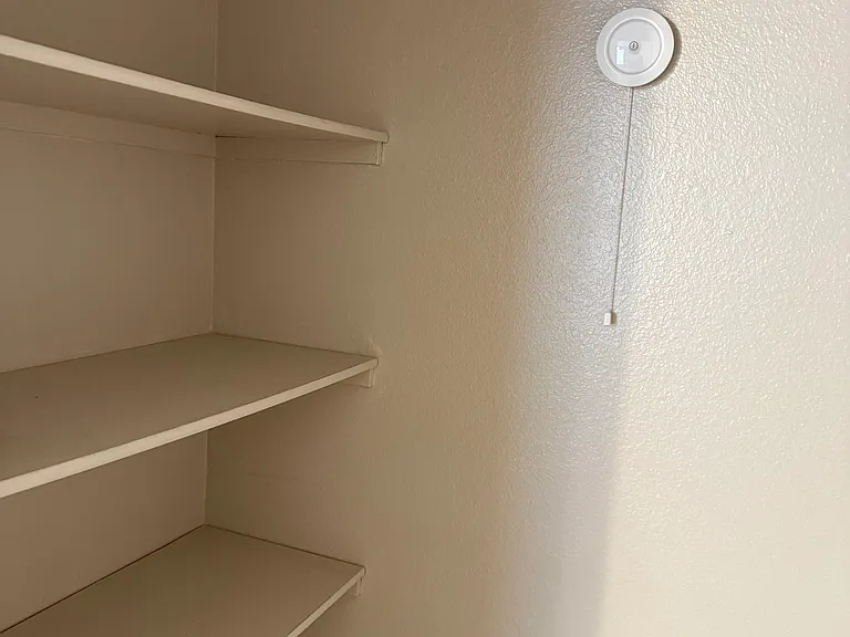 Closet with draw string light.
