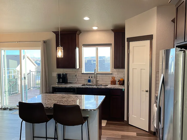 Kitchen with view of walk out to deck