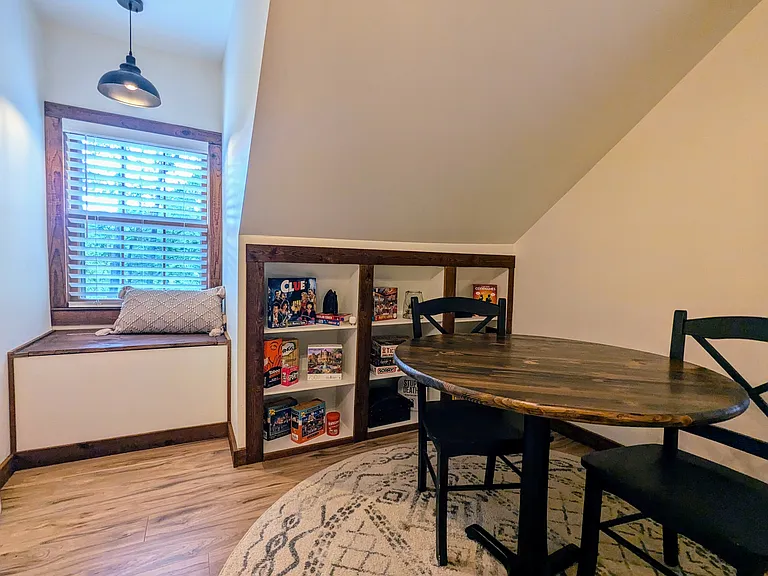 UPSTAIRS BEDROOM 2: Games, Puzzles, Books and More! Plus, a small two-person table perfect for completing a puzzle on a rainy day!