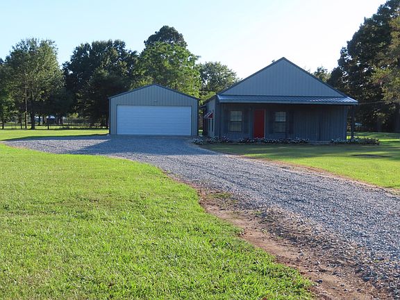 Front of home and front of detached garage. Showing more of the driveway