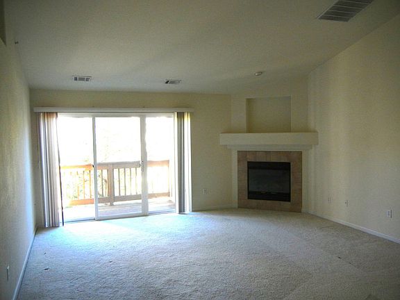 Living room, fireplace, deck with storage closet; new wood planks will be installed