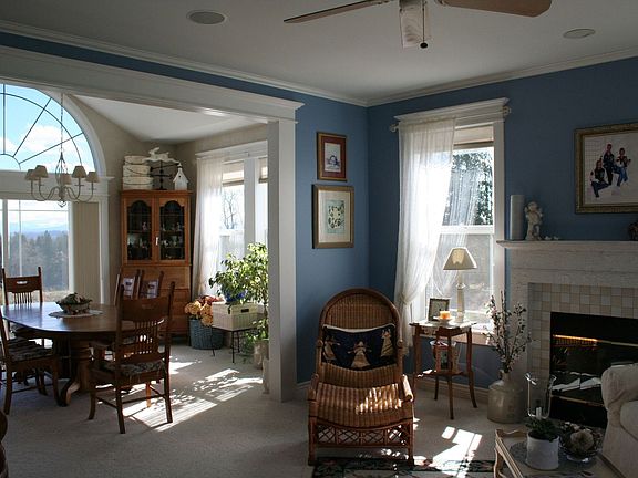 Formal dining and living rooms look out at manicured lawn and Mt. views