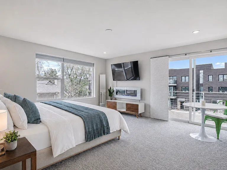 Primary suite with ensuite bathroom, large walk in closet, and balcony