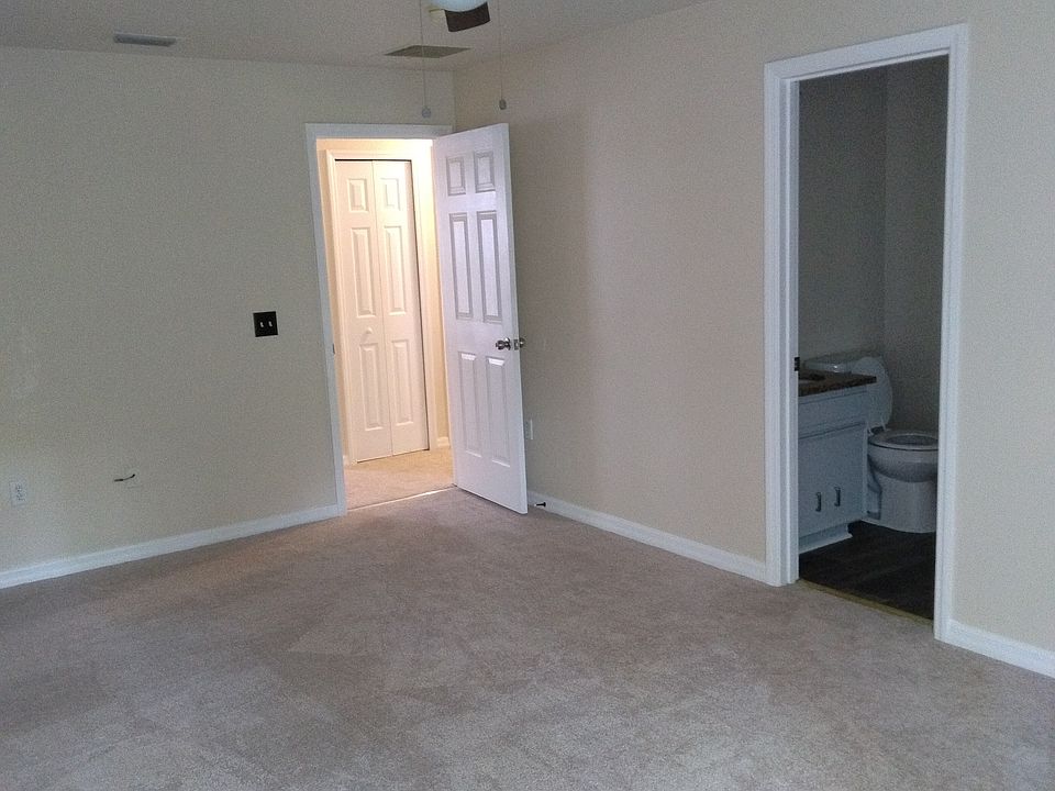 Large master bedroom with new ceiling fan installed.