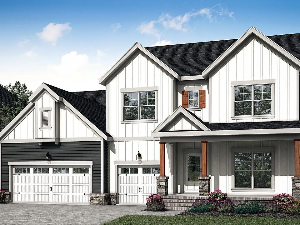 Experience elegant design with white vertical siding, wooden shutters and stone pillars in Brush Cre