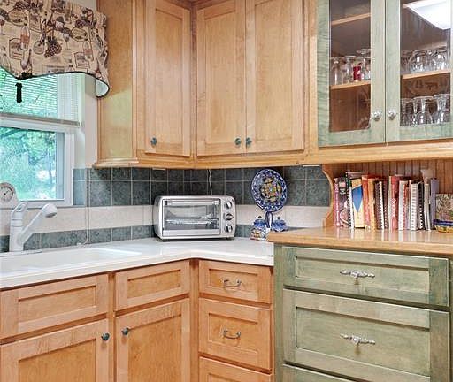 Custom built cabinets add charm to this bright and cheerful kitchen!