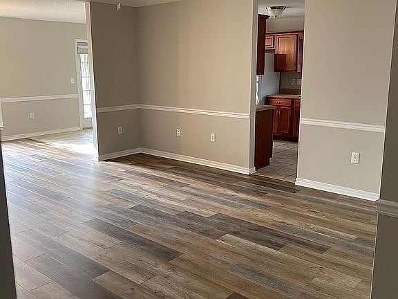 Living room looking into kitchen and dining room