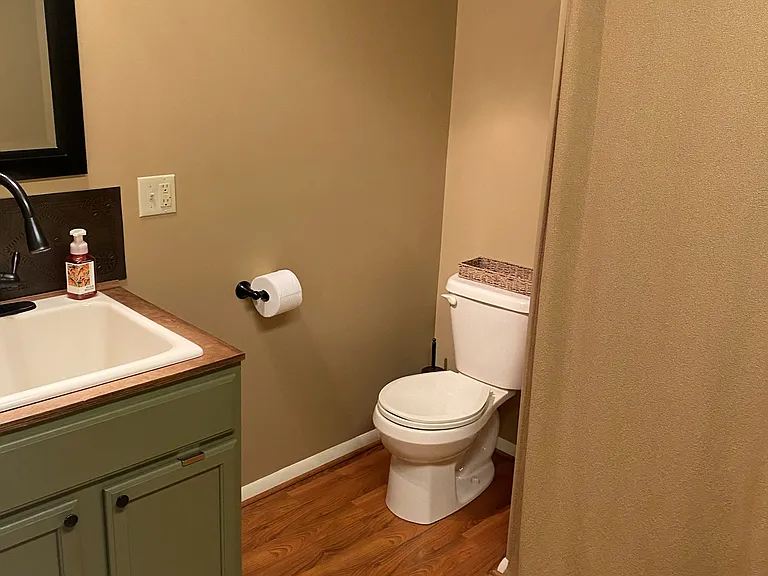 (3 of 3) Half bath/ laundry room with a closet for cleaning supplies near the rear entrance mud room.