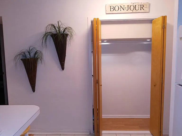 Welcome to the condo. Hall entry closet view from kitchen