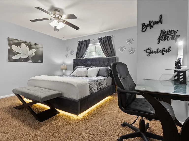 Kingsize bedroom with designated workstation, chair, desk, lamp, walk-in closet, 43 inches smart TV, ceiling fan, blackout curtains