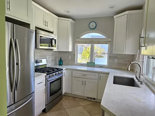 Fully-equipped white marble kitchen with stainless steel appliances - 427 19th St