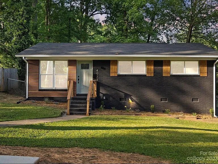 Welcome home! This brick home features a large front lawn with several young tress, new windows, and beautiful wood accents.
