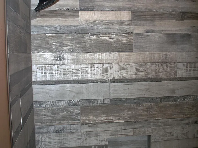 Fully remodeled master bathroom tub and shower with wall-to-wall imported tile and bronze fixtures.