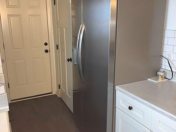 Stainless steel appliances. Past the kitchen you will find a bathroom, basement and garage.