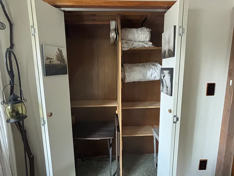 This closet could be a pantry or for living room storage