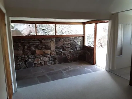 East stone wall and side entrance