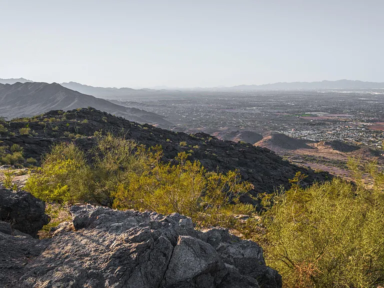 Elevated desert setting with sweeping mountain and city views, offering a scenic backdrop and outdoor recreation nearby.