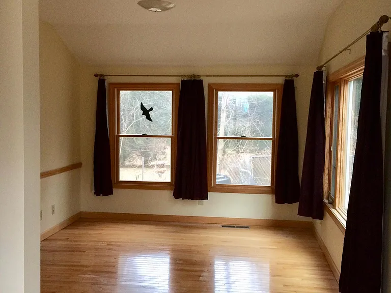 bedroom at north end of house facing garden spot and backyard (10.5' x 13') Attached to this is a step up to an 8' x 8' space with a bay window great for plants. There's a sliding glass door that leads from this space to an outdoor patio.