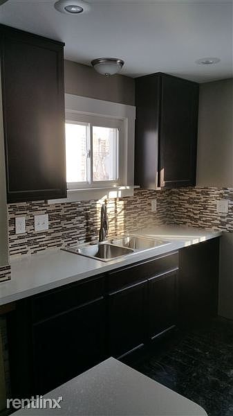 completely updated kitchen with mosaic glass backsplash and