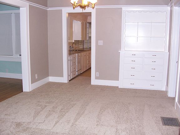 Dining room w/hutch; view into kitchen