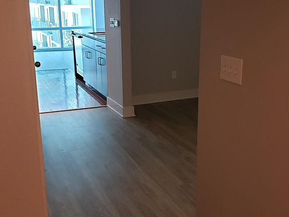 View from the front door looking at sleeping area adjacent to the kitchen.