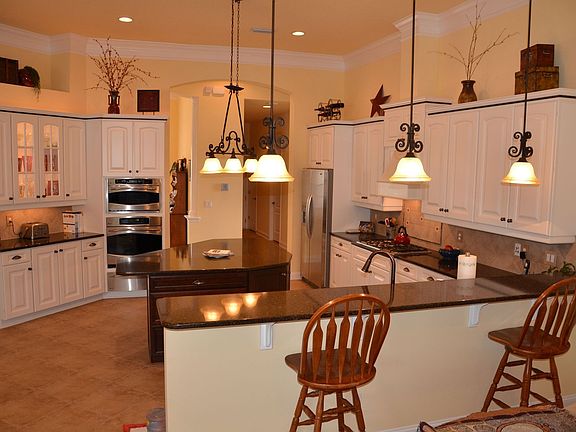 Gourmet Kitchen With Breakfast Bar & Custom Pendant Lighting
