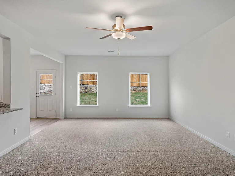 The spacious family room has large windows that let in great natural light and backyard views.