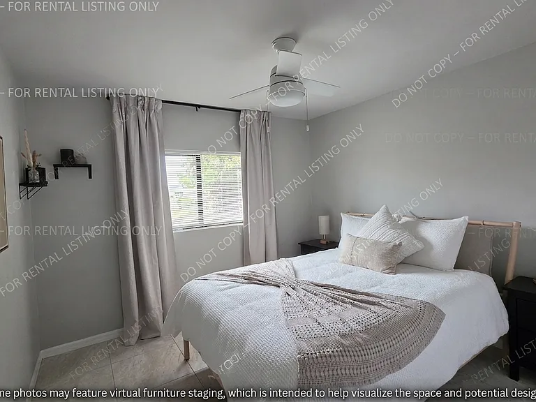 This bedroom offers a bright, inviting space that seamlessly blends with the apartment's modern design. Its clean aesthetic and tranquil atmosphere make it a versatile room, perfectly suited for a comfortable guest room or a peaceful second bedroom