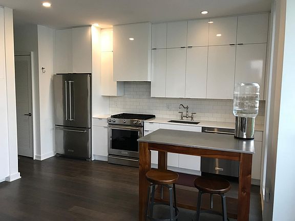 Gourmet kitchen with stainless steel appliances and quartz countertops.