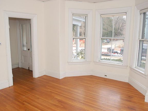 Living room with bay window. Front entry hall on left.
