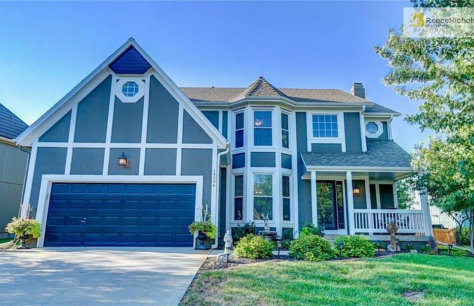 Storybook front elevation with fresh exterior paint in neutral gray.
