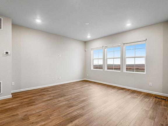 Bright and open great room with wide-plank laminate wood color floors
