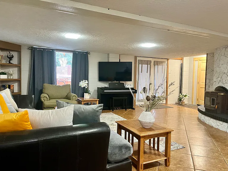 Living room with wet bar, 55" TV and electric piano