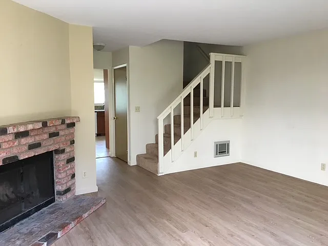 Front Room showing vinyl plank floor, fireplace ad stairs - 1805 Chalcedony St