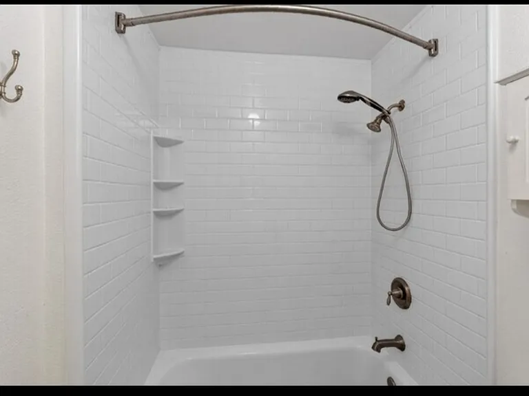 Recently installed shower/tub with freshly painted walls