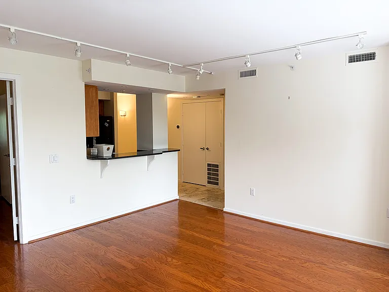 View of kitchen and entry from living room window side.