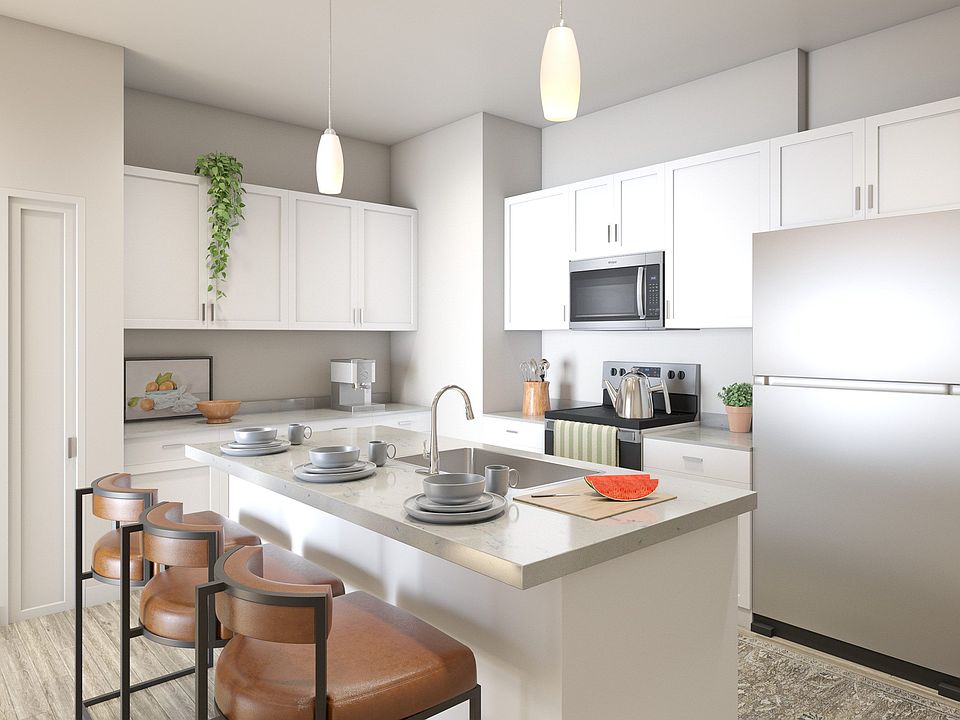 Flats at Sugar Run Delaware Ohio apartments showing a kitchen with white cabinets and a refrigerator.