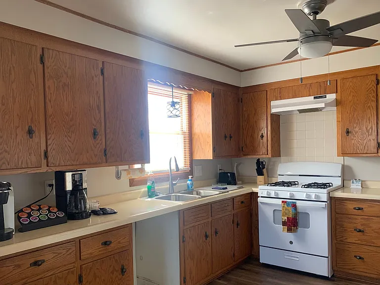 Kitchen fully equipped with everything you need to eat and cook with. (Plates, cups, bowls, silverware, and pots and pans)