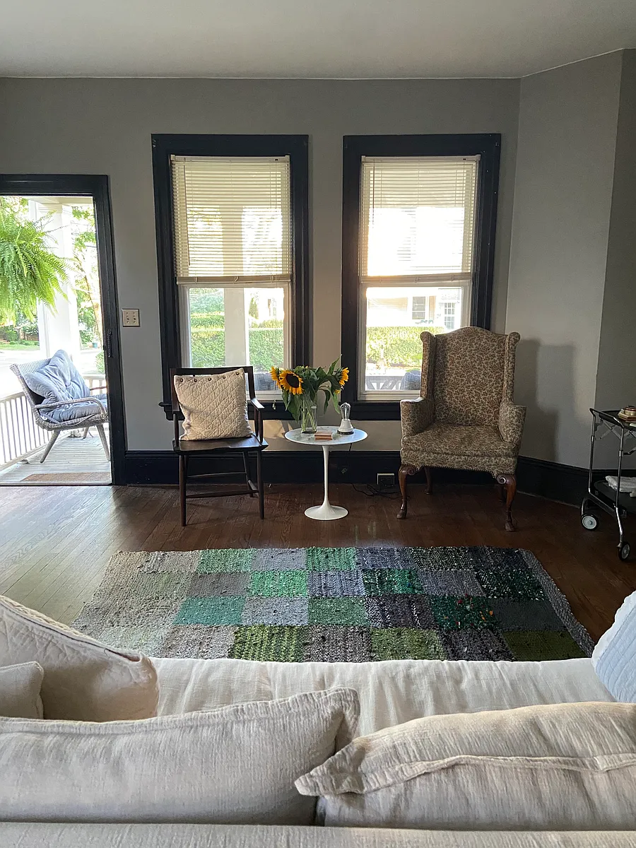 Living Room area of the combined Living Room + Dining Room, with the photo being taken from the Dining Room. This very large and open room at the front of the apartment has lots of windows and loads of natural light leading directly onto the front porch. - 30 Wiggins St #1