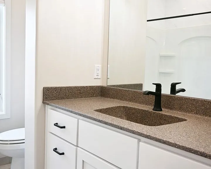 Bathroom with a large vanity and mirror.