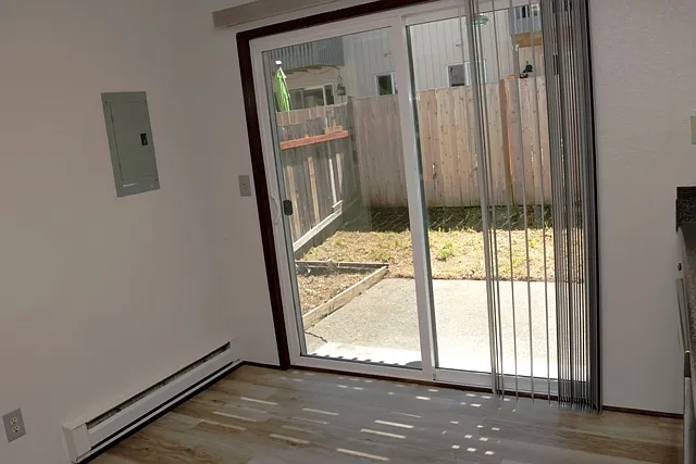 Patio slider leading to fenced backyard