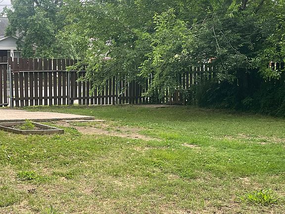 View from middle of the yard near the second concrete patio toward the front. Lovely well shaded area, mulberry tree makes for yummy cobblers! A sweet redbud can be seen out the back windows.
