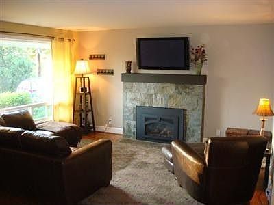 Hardwood flooring, baseboard molding, decorator colors, 3 panel doors, and cute light fixtures greet