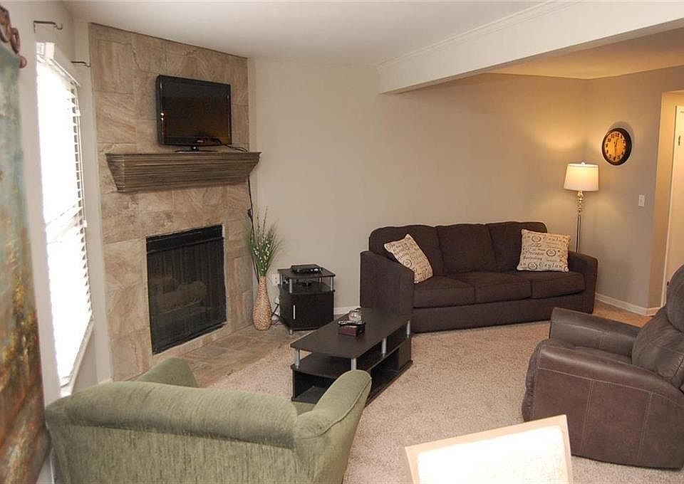 New floor to ceiling ceramic tile added around fireplace.