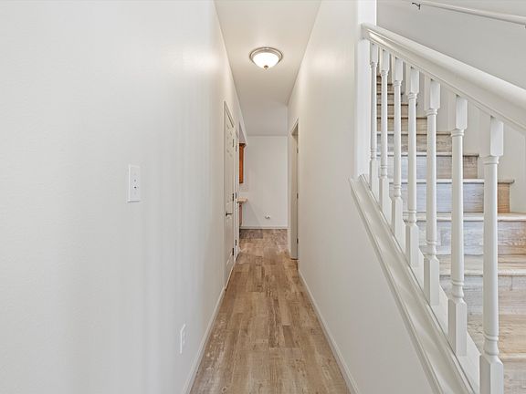 hallway from entry door to garage, 1/2 bath and kitchen
