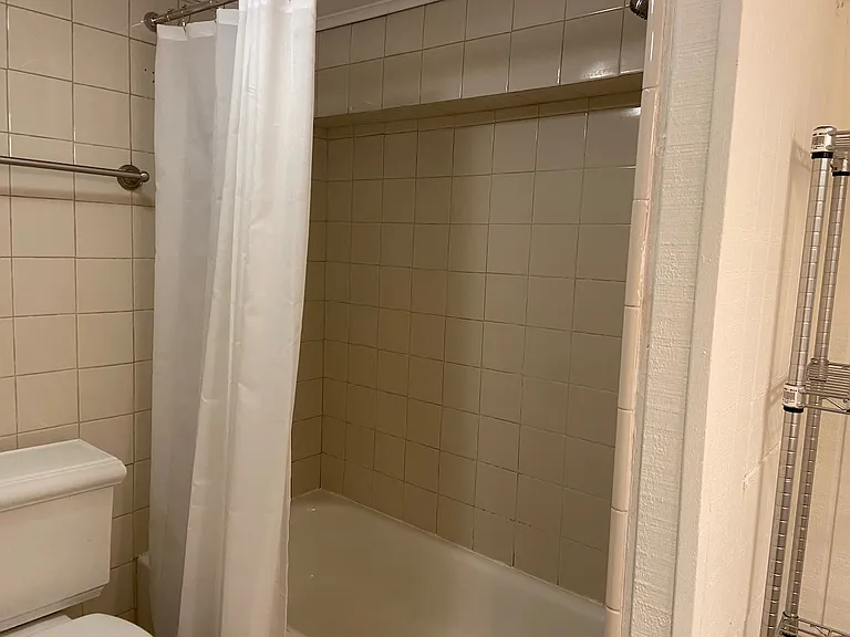 Bath with tub and shower.