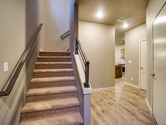 Wide staircase with modern metal railings