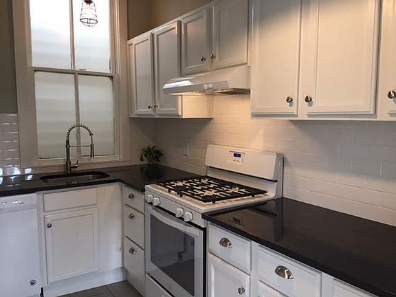 Kitchen with subway backsplash and solid granite counters