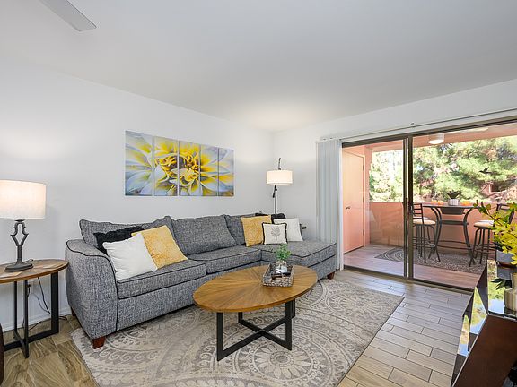 Living room has leather recliner and large sofa bed couch with chaise for four.